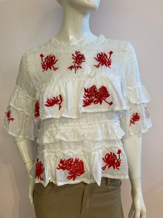 White top with ruffle and red embroidery