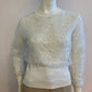 Small ribbed white sweater lined with sequin tulle