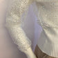 Small ribbed white sweater lined with sequin tulle