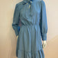 Blue skater dress with ruffle and knot at the neck