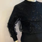 Small ribbed black sweater lined with sequin tulle