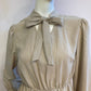 Beige skater dress with ruffle and knot at the neck
