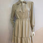 Beige skater dress with ruffle and knot at the neck