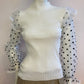 White ribbed sweater with puff sleeves in plumetis tulle
