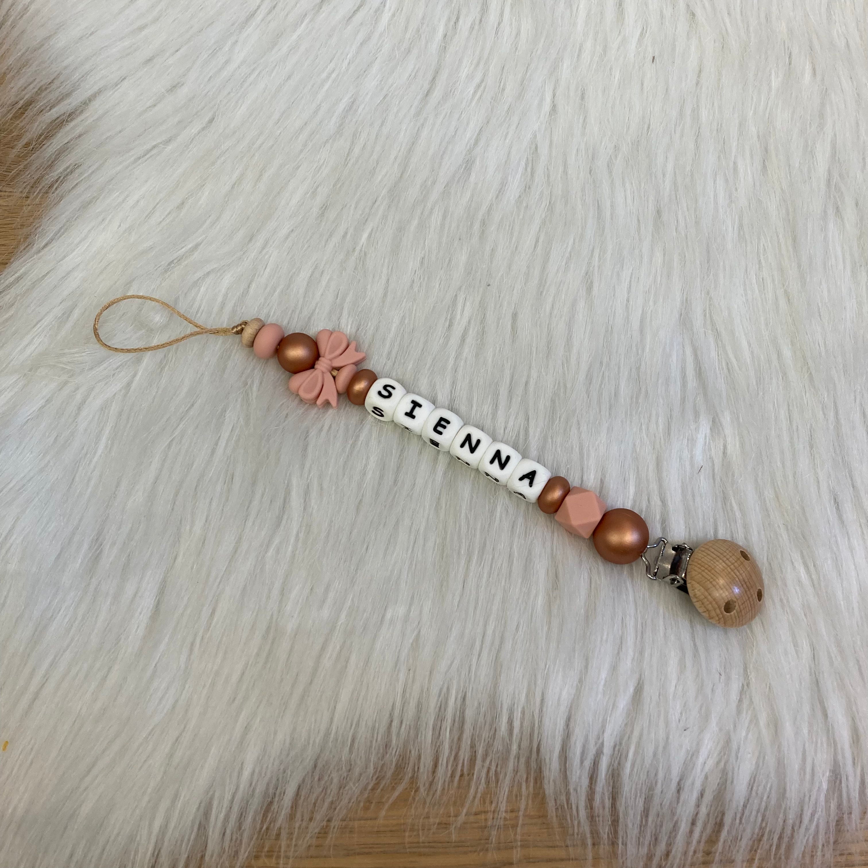 Speenkoord poeder roze strikje roze/koper tinten