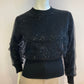 Small ribbed black sweater lined with sequin tulle