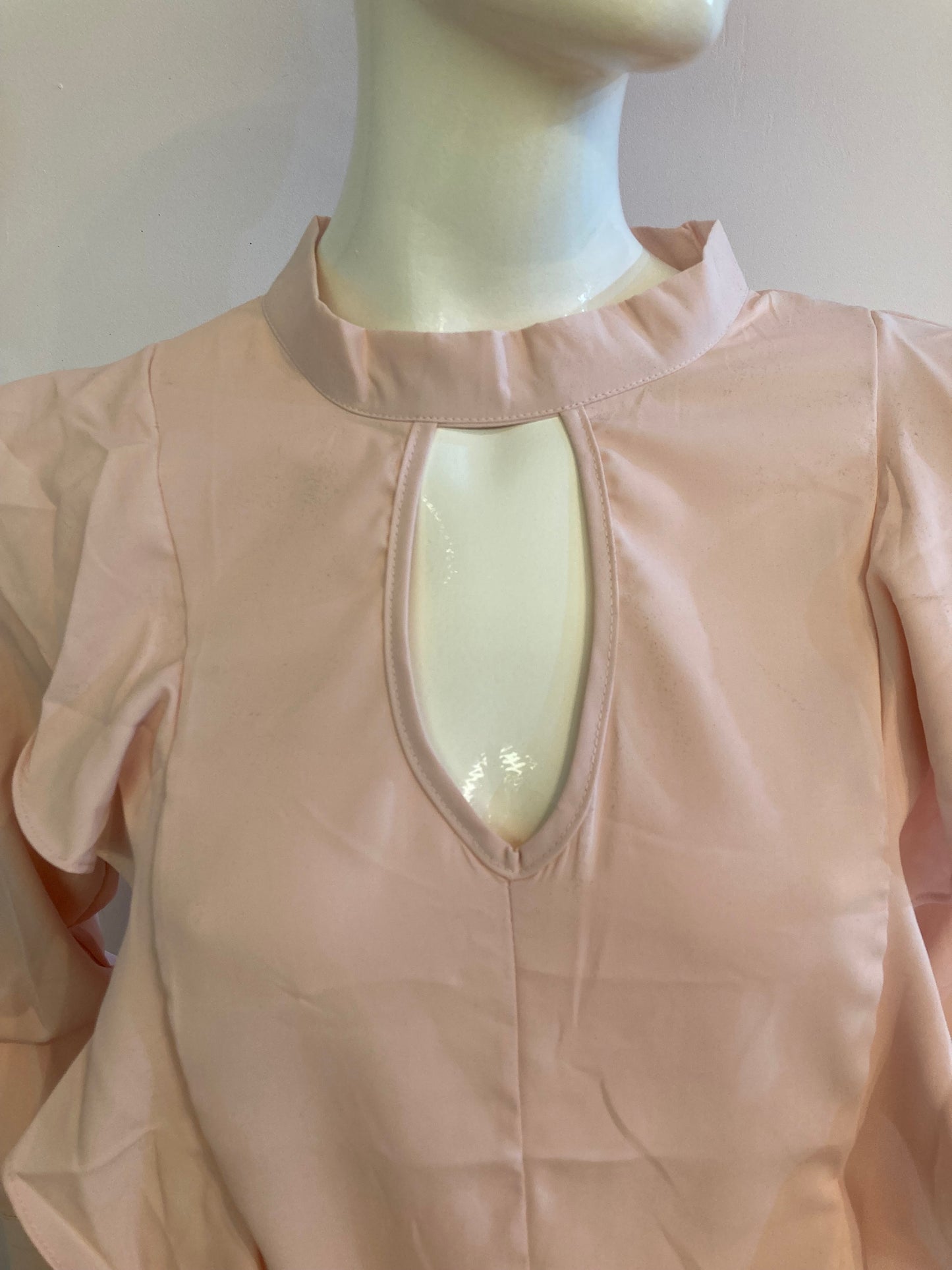 Chic pink blouse with long sleeves and ruffles