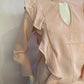Chic pink blouse with long sleeves and ruffles