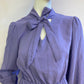 Lilac skater dress with ruffle and knot at the neck