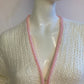 Fluffy white cardigan with pink outline
