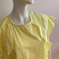 Yellow blouse with ruffle and three buttons on the shoulders