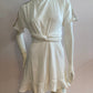 White skater dress with gold and colored yoke on the arms and open back