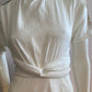 White skater dress with gold and colored yoke on the arms and open back