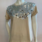 Beige top with large silver sequin on the front