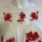 White top with ruffle and red embroidery