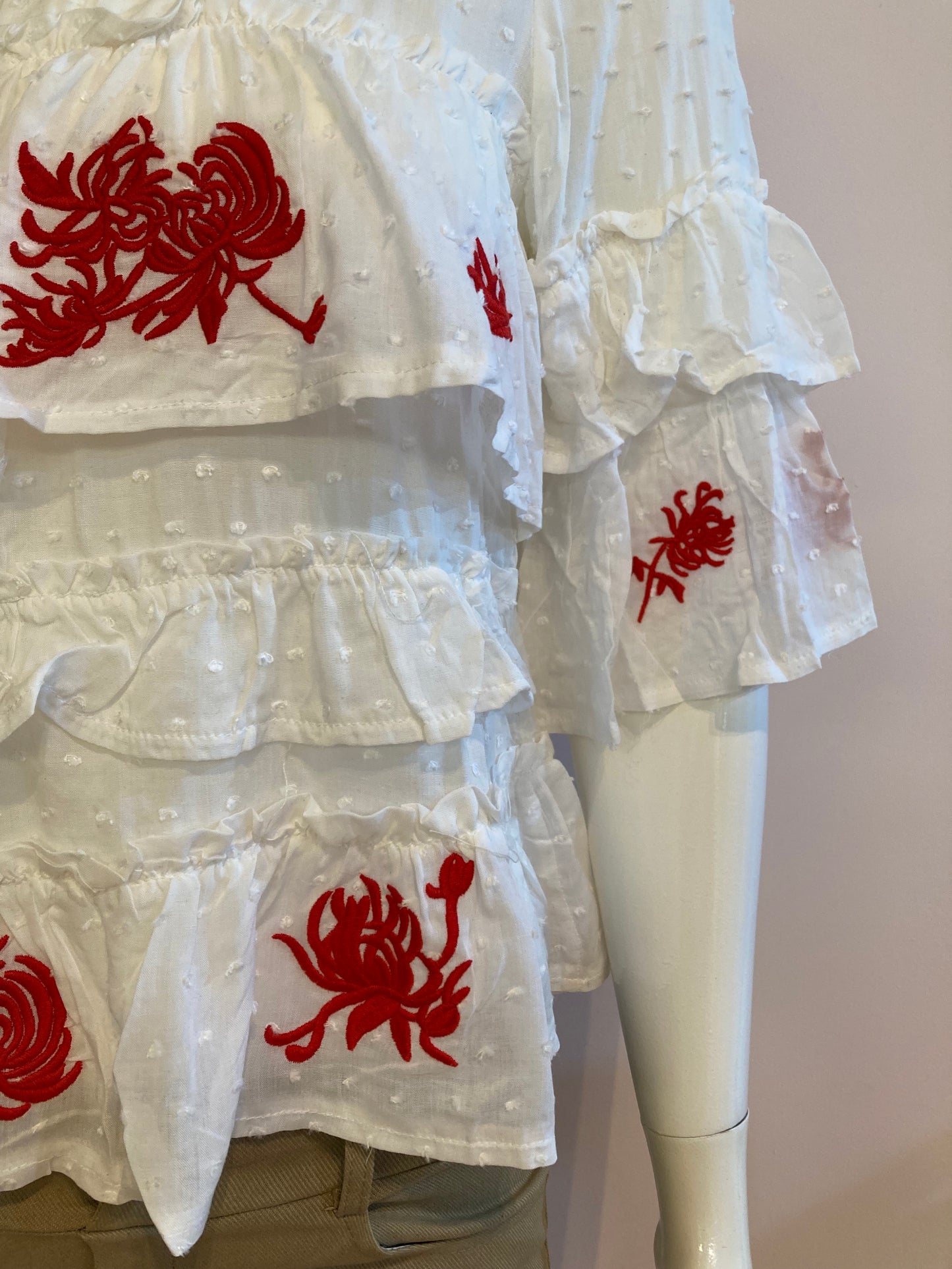 White top with ruffle and red embroidery
