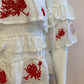 White top with ruffle and red embroidery