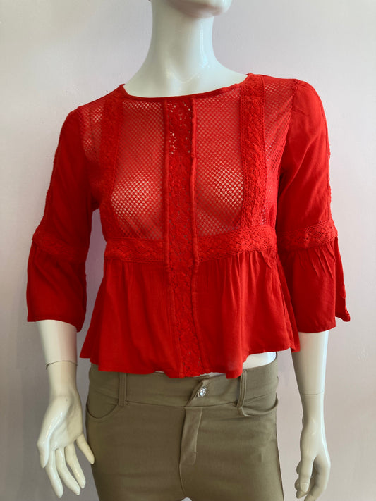 Red blouse with lace on the front and ruffles.