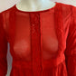Red blouse with lace on the front and ruffles.