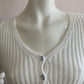 Nice short ribbed white cardigan with shiny buttons