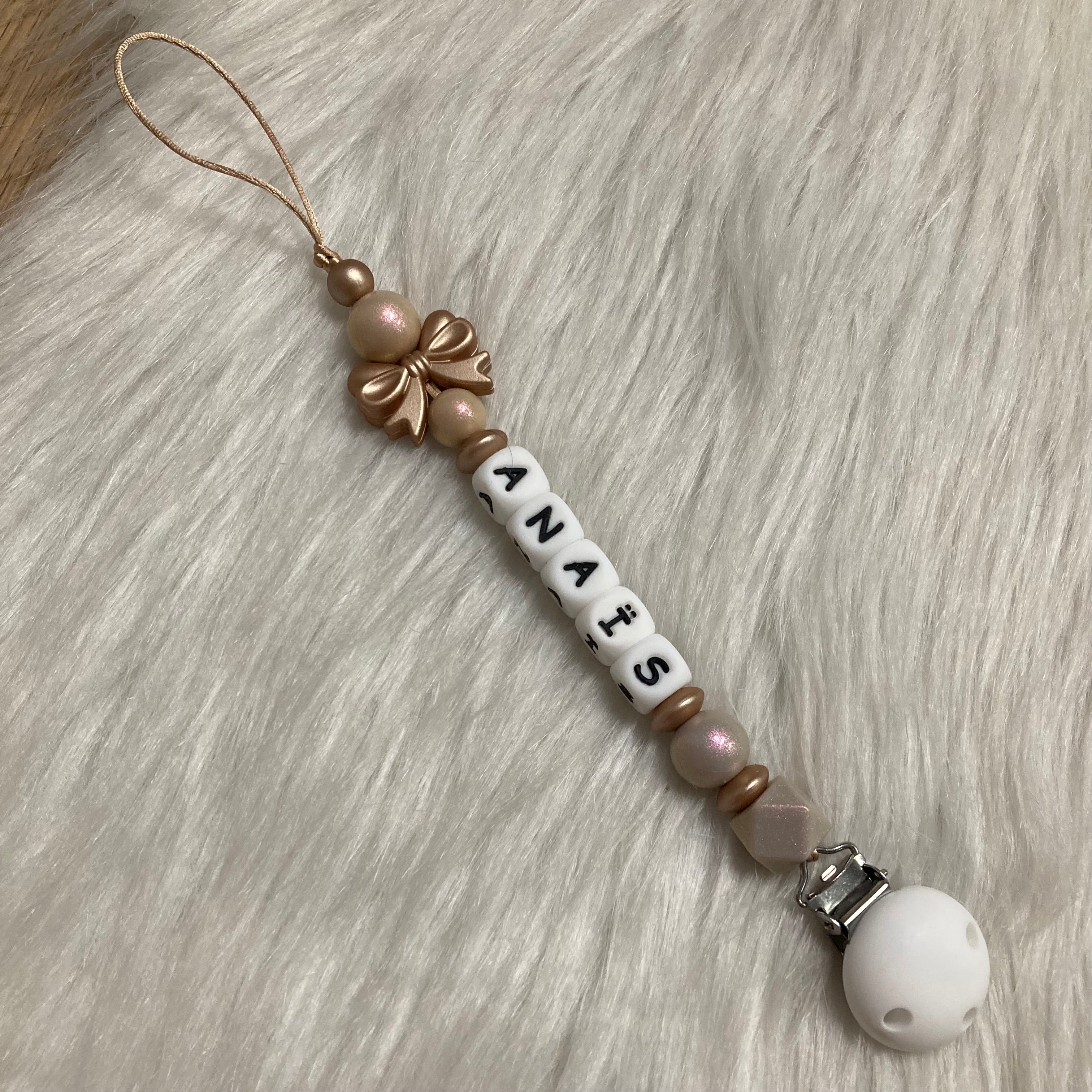 Speenkoord gouden strikje goud/parelmoer shiny tinten