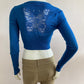 Short cardigan in blue with lace pattern on the back