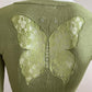 Short cardigan in green with lace pattern on the back