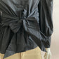 Black shirt with puffed sleeves and integrated belt